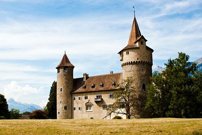 com landscape photo of castle near the mountain unsplash.