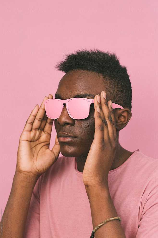 youngblackmanwithapinkglassesonpinkbackground