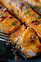 lightly charred Honey garlic salmon flakes with fork, ready to eat
